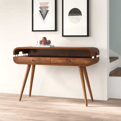 A great option for creating an eye-catching décor display, or storing post and keys, console tables round out your living room or hallway with a welcoming touch. Sure to create an eye-catching look, this design is crafted from solid ash wood and features an oval silhouette with spindle legs and sleek cutouts for a retro-inspired twist. Two drawers and a shelf lend this table a bit of extra storage for essential items. Interior Design Kitchen Contemporary, Console Table Design, Console Table Hallway, Hallway Table, Wood Console Table, Wood Console, Essential Items, Decor Display, Console Tables