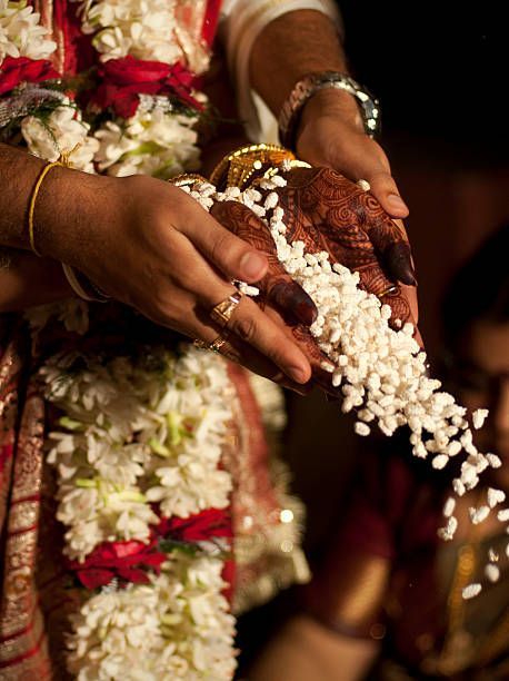 The bride and the groom together offering parched rice into the... Telugu Brahmin Wedding, Post Wedding Photoshoot, Brahmin Wedding, Indian Wedding Aesthetic, Temple Wedding Photography, How To Get Married, Bengali Culture, Bride Photos Poses, Wedding Photoshoot Props