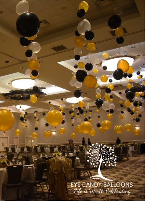 Glamourizing this ballroom for a big formal event! From the many bubble strands hung from the ceiling to the large 30" gold balloons used as centerpieces around the room.  #eyecandyballoons #nhballoons #balloons #balloondecor Formal Events Decorations, School Banquet Ideas, Ceiling Balloons Decorations, Balloon Hanging From Ceiling, Hang Balloons From Ceiling, Hanging Balloons From Ceiling, Ceiling Balloon Decorations, Nye 2024, Anniversary Balloons