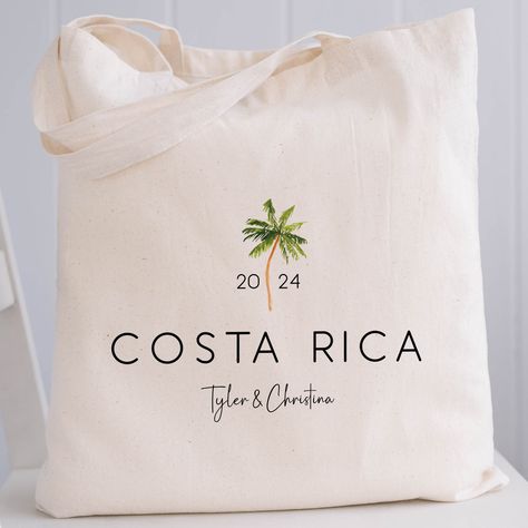 These palm tree print canvas tote bags are a fun way to celebrate a destination wedding, vacation, or other special event. Choose our roomy, gusseted tote bags with handles in our economy or premium heavy canvas style, our canvas drawstring backpacks, or one of 3 sizes of our popular drawstring canvas bags. Customize your bags with the year, your destination, and 1 line of text. 𝝗𝗨𝗟𝗞 𝗣𝗥𝝞𝗖𝝞𝝢𝗚 Scroll down for tips on bulk pricing and how to place your order.  𝗣𝗘𝗥𝗦𝗢𝗡𝗔𝗟𝗜𝗭𝗘 𝗬𝗢 Key West Welcome Bags, Tropical Favors For Guests, Destination Wedding Goodie Bags, Destination Wedding Gift Bags, Welcome Bags For Wedding Guests, Destination Wedding Welcome Bags, Palm Tree Wedding, Wedding Goodie Bags, Wedding Guest Bags