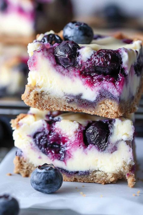 A close-up of a blueberry cream cheese bar with a bite taken out, revealing the rich cheesecake texture and juicy blueberry filling, topped with whole blueberries. Blueberry Cream Cheese Bars, Blueberry Topping For Cheesecake, Cream Cheese Bars Recipe, Blueberry Cheesecake Bars, Cheese Bars, Blueberry Filling, Blueberry Bars, Rich Cheesecake, Cream Cheese Bars