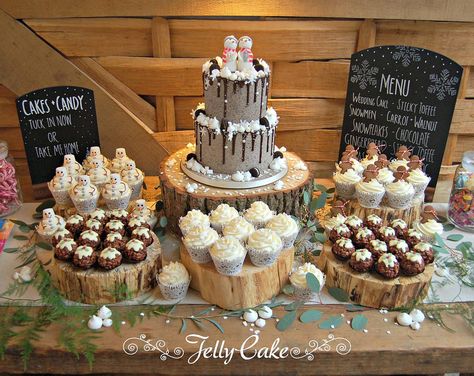 The full dessert table for Chloe and Jay's wedding at Cripps Barn, Bibury. A two tier cake, cupcakes with gingerbread men, snowmen and snowflake decoration and chocolate rice krispie Christmas puds. Christmas Wedding Dessert Table, Winter Dessert Table, Dessert Table Ideas, Christmas Wedding Cakes, Christmas Dessert Table, Toffee Cake, Cupcake Stand Wedding, Tie The Knot Wedding, Two Tier Cake