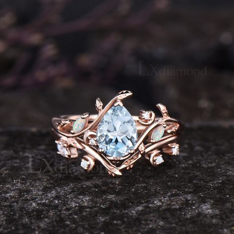 Item description ✦ Handmade, high-quality item! ✦ Material: Solid 10k/14K/18K GOLD (can be made in white/rose/yellow gold) Engagement ring ✦ Center stone: Natural Aquamarine ✦ Size/Weight: 6x8mm Pear Cut ✦ Side stones: Marquise Cut Lab Opals and Round Cut Moissanites. Wedding bands ✦ Gemstones: Lab Opals and Moissanites. Any ring size can be made,if the ring size is not in the option list ,contact me. As it is handmade,it needs 2-4 weeks to finish and then be shipped by usps or DHL. Return policy: We offer 30 days return policy. For any reason, if you are not completely satisfied with your order, you may return it for a refund.  Buyer is responsible for the handcraft fee (15%-30% of the total price) and the return shipping cost. Moon Stone Engagement Ring, Fairytale Engagement Rings, Stylish Jewelry Accessories, Pretty Engagement Rings, Unique Engagement Ring Settings, Unique Opal, Cute Engagement Rings, Yellow Gold Engagement Ring, Nature Inspired Rings