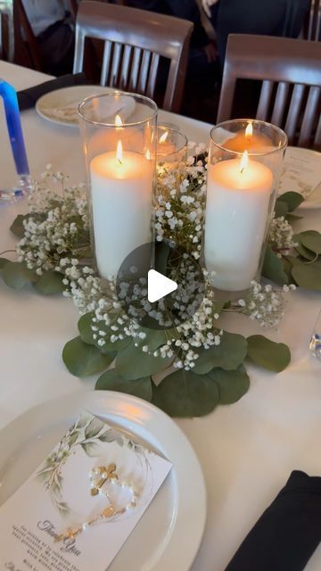 Orlando Party Rentals & Decor on Instagram: "Are you looking for a Baptism Centerpieces that transform your tables into a elegant and charming decoration? ✨ Our latest creation features the delicate elegance of eucalyptus, the charm of baby’s breath, and the warm glow of candles. Watch the magic unfold!  . . . . . #partydecor #orlandopartydecorations #orlandopartyplanner #orlandoflorida #orlandopartyrentals #partyrentals #partyrentalorlando #balloondecor #orlandoballoons #orlandopartydecor #kidspartydecor #kissimmee #wintergardenfl #orlandolocal #lakemary #lakenona #saintcloud #windermerefl #balloongarland #genderreveal  #baptismcandle #baptism" Baby Girl Baptism Centerpieces, Eucalyptus And Baby Breath Centerpiece, Baptism Decorations Table, Baptism Centerpieces Ideas, Baptism Centerpieces For Boys, Girl Baptism Ideas, Flameless Candle Centerpiece, Baptism Table Decor, Baby Baptism Party