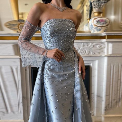 SS484 Find your sparkle, wear it boldly! ✨ Check the homepage to see more dress designs. WhatsApp: +86 189 0682 5543 #eveningdresseswholesale #dubaidress #eveningdress #weddingpartydress #bridalfashion #worldwide #EveningWear #sharonsaid #eveningdressmanufacturer Gown With Overskirt, Gray Evening Gown, Dubai Evening, Yellow Evening Dresses, Grey Evening Dresses, Grey Gown, Champagne Evening Dress, Gold Evening Dresses, Dress Pesta