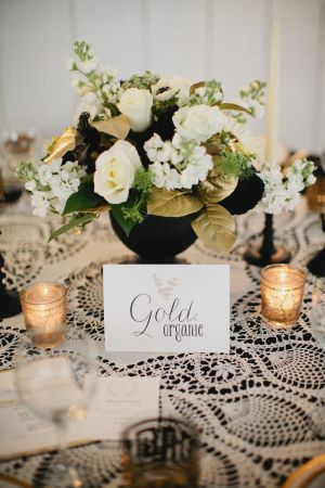 White and Gold Flowers in Black Vase | photography by http://www.kristynhogan.com/ | Venue, Floral, Event Styling, Decor, and Custom Signage by http://www.cedarwoodweddings.com/ Black White Gold Silver Wedding Centerpieces, Gold Painted Flowers, Black White Gold Floral Arrangement, Black And Gold 50th Anniversary Centerpieces, Black White Gold Flower Arrangements, Black White Silver Flower Arrangements, Black Gold Flower Arrangement, Black White And Gold Floral Arrangements, Black And Gold Centre Piece