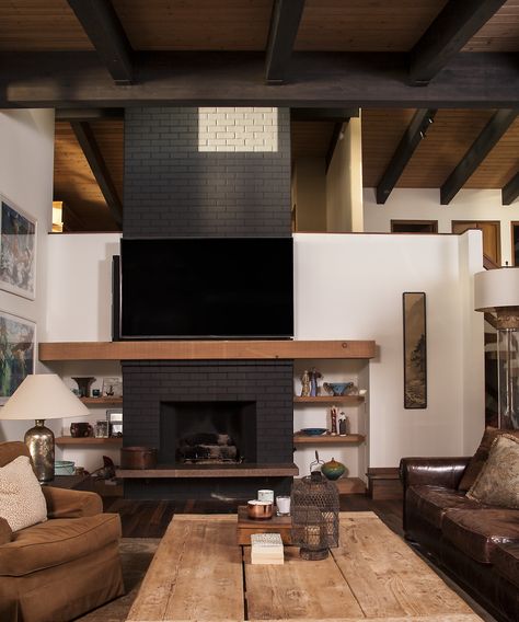 Mid-Century Modern Brick Fireplace Painted Black. Light wood mantle and built-in shelving. Light wood vaulted ceiling with exposed beams stained black. Fireplace Painted Black, Black Fireplace Decor, Brick Fireplace Painted, Fireplace Painted, Black Brick Fireplace, Mid Century Modern Fireplace, Mid Century Fireplace, Wood Mantle Fireplace, Vaulted Ceiling Living Room