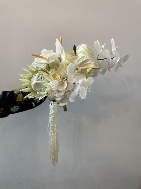 This is a foliage free, abstract, elegant, moderen bridal bouquet. Made with big Blooms such as orchids, protea and anthuriums. This Bouquet is a stunning statement bouquet, made by one of our talented wedding florists here at Bourbon Rose in Christchurch Cantervury NZ. Head to www.bourbonrose.co.nz to enquire xx #weddingbouquet #bridalbouquet #abstractbouquet #christchurchweddingflorist #bigbloomweddingbouquet #whiteweddingbouquet White Anthurium Bouquet, Protea Wedding Bouquet, Bourbon Rose, Anthurium Bouquet, Bridal Bouquet White, Abstract Wedding, Protea Bouquet, Orchid Centerpieces, Jeepers Creepers