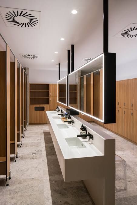 Gym Washroom Design, Gym Toilets Interior Design, Gym Vanity Area, Public Changing Room, Office Bathrooms Business, Corporate Office Washroom Design, Commercial Toilet Design Interiors, Fancy Public Bathrooms, Bathroom Office Design