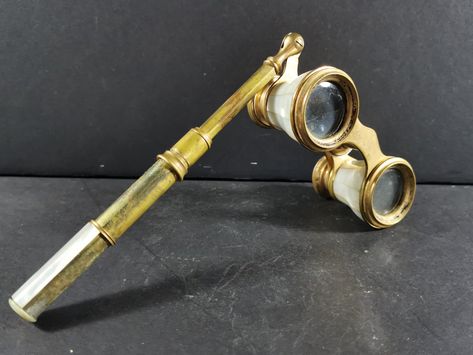 This antique opera glasses lorgnette is a beautiful piece from the Victorian era, crafted from mother of pearl and brass. It's an exquisite accessory that would make a great addition to any collection of antiques. With its elegant design and intricate details, it is sure to impress any viewer. The lorgnette has a rich history, dating back to the 1800s and is a true testament to the craftsmanship of that era. The time period manufactured is pre-1930, making it a rare find in today's market. Wheth Opera Glasses Vintage, Victorian Objects Antiques, 1800s Accessories, Harpy Oc, Victorian Glasses, Antique Binoculars, Antique Artifacts, Victorian Items, Antique Jewelry Victorian