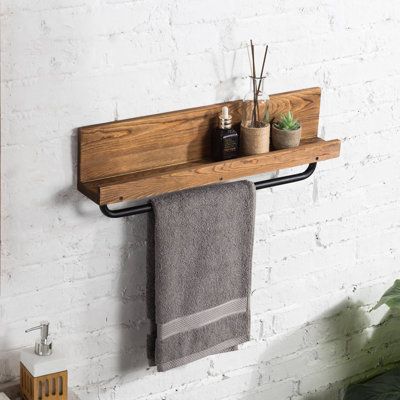 Featuring an intriguing blend of rustic and industrial style, this wall-mounted burnt wood and metal pipe towel hanging rack is a great way to add functional organization and a unique decorative accent to your bathroom or kitchen. This towel rack includes a metal bar for hanging towels, as well as a top shelf for storing supplies and accessories. Featuring a distinctive torched wood and industrial metal aesthetic, this towel bar is an excellent decorative complement to your bathroom, kitchen, or Hanging Bath Towels, Rustic Towel Rack, Wood Towel Rack, Hanging Towel Rack, Bathroom Wood Shelves, Wall Towel Racks, Bathroom Shelf With Towel Bar, Diy Towel Rack, Mounted Towel Rack