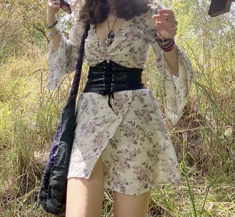 Corset belt floral dress doc martins mandela bag earth tones crystal bracelet necklace rose grass picnic aesthetic cute Floral Dress With Corset, Corset Over Outfit, Corset Belt Dress Outfit, Styling A Corset Belt, Corset Belt Aesthetic, Corset Belt With Dress, Corset Belt Outfit Dress, Corset Belts Outfit, Corset Belt Outfit Aesthetic