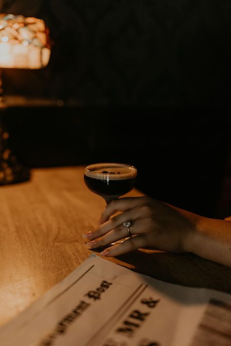 A couple enjoying drinks at a bar, engagement newspaper closeup. This couple's editorial bar engagement shoot in Tennessee were so moody and romantic! See tons of moody engagement photos, dark and moody engagement shoot and classy bar engagement photos. Book Mataya to capture your Tennessee engagement pictures at matayabuck.com! Moody Bar Engagement Photos, Moody Romantic Engagement Photos, Pub Engagement Photos, Cocktail Bar Engagement Photos, Engagement Newspaper, Speakeasy Engagement Photos, Cocktail Editorial, Engagement Photos Dark, Edgy Engagement Pictures