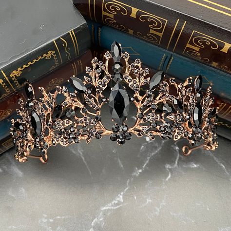 Vera's Tiara is a beautiful landscape of black crystals. Vine details set into rose gold colored metal add a theme of nature in a sea of liquid black. Large marquise shaped black crystals provide a gorgeous focal point. Total Length End to End: 14.5 Inches Max Height At Center: 2.5 Inches Width Loop to Loop for Head: 6 Inches Tiara is adjustable by carefully bending and stretching the ends apart to fit most hair styles and head sizes. Tiara features loops on each end to secure to hair with bobby Black And Rose Gold Crown, Black And Gold Tiara, Holographic Fashion, Black Tiara, Queens Tiaras, Rose Gold Tiara, Beautiful Tiaras, Gold Tiara, Black Jewel