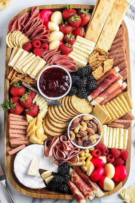 Learn how to make an easy Charcuterie board for your next party and totally impress your guests. You will be pleasantly surprised how simple it is to make. We have simple ideas to build a DIY charcuterie board everyone will love even the kids. These ideas are perfect for brunch, Christmas, 4th of July and more. #eatingonadime #howtomakeaCharcuterieboard Make A Charcuterie Board, A Charcuterie Board, Cheese Crackers, Charcuterie Board, Crackers, Cheese, Fruit