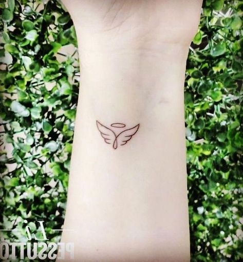 small-angel-wings-tattoo-wrist-tattoo-green-bushes-in-the-background Tattoos For Women Small Meaningful, Tattoo Angel, Tattoo Family, Angel Tattoos, Knight Templar, Female Tattoos, Shape Tattoo, Meaningful Tattoos For Women, Angel Wings Tattoo