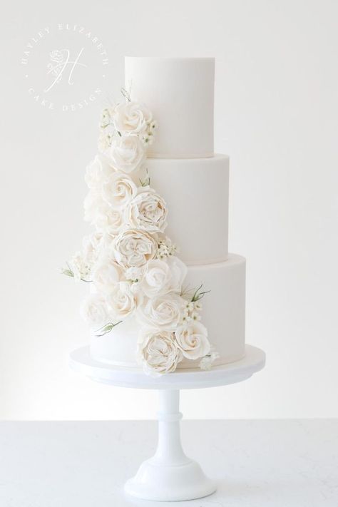 White wedding cake designs in Hampshire | elegant wedding cake by Hayley Elizabeth | wedding cakes elegant romantic | elegant white wedding cake | all white wedding cake classy | wedding cake with sugar flowers | all white wedding cake ideas | luxury wedding cake design | fine art wedding cake | white wedding | luxury white wedding #weddingcakes #whitewedding Buttercream White Wedding Cake, Romantic Wedding Cake 3 Tier, Plane White Wedding Cake, Clean White Wedding Cake, His And Her Cake Wedding, Stunning Wedding Bouquets, All White Wedding Cake With Flowers, White Wedding Cake With Roses, Modern 4 Tier Wedding Cake