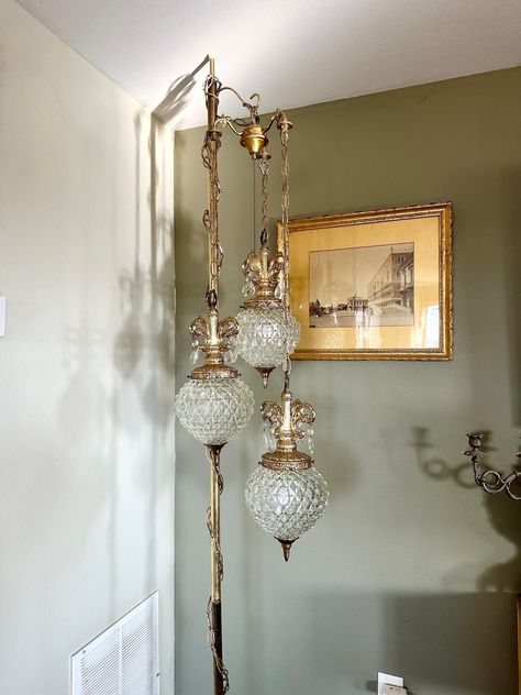 Rare, clear-glass triple globe swag lamp with pineapple tops and hanging prisms. Has unique chain design and fancy pull switch that controls the three different lighting options as shown in video. There are no defects, all prisms are attached, and works great! Does NOT include the 8 foot tension pole it is suspended from in the photos. Free shipping. Measurements in listing photos. Dinning Room Lights Vintage, Home Decor Antique Modern, Antique Lights Hanging, Statement Lamp Living Room, Vintage Hanging Lamp, Swag Lamp Bedroom, Vintage Diy Room Decor, Diy Mood Lighting, Glamorous Home Decor