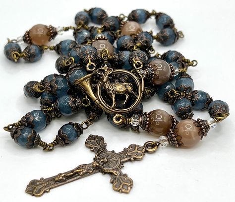 "RADITIONAL 5 DECADE ROSARY FEATURING St Hubert Vintage Replica Centerpiece The Aves are natural AAA grade 8 MM Blue Jade. The Paternosters are 10 MM Moonstone capped in bronze. The vintage reproduction 2\" Crucifix compliments this piece. This is considered an \"unbreakable rosary.\" -as each bead is individually wire wrapped and should never come apart. It will drape beautifully around your hand." Bronze Centerpiece, St Hubert, Decade Rosary, Jesus And Mary Pictures, Blue Jade, Catholic Jewelry, Catholic Rosary, Casual Jewelry, Rosary Catholic