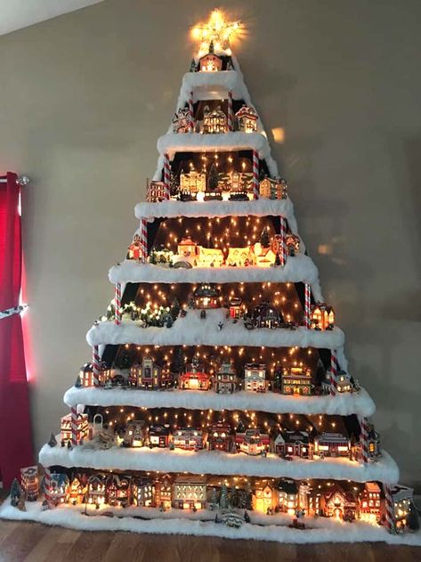 Wall Christmas Village Tree #Christmas #trees #decorhomeideas How To Make Christmas Village Tree Display, Christmas Display Shelf, How To Store Christmas Village Houses, Christmas Village Display Shelf, Christmas Dome Displays, Christmas Tree Placement In Living Room, Ways To Display Christmas Village, Christmas Houses Village Display, Christmas Village Stand