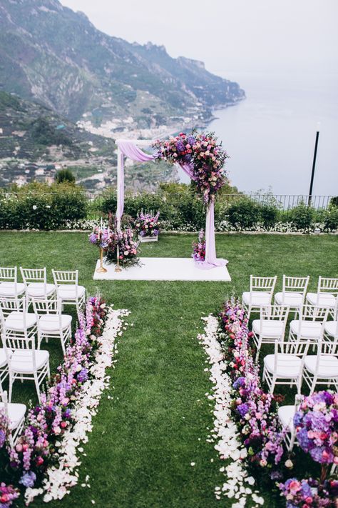 Stunning wedding arch and aisle decor with gorgeous purple florals and fabric draping. Fabric Draping Wedding, Wedding Ceremony Places, Purple Wedding Ceremony, Lilac Wedding Themes, Lavender Wedding Theme, Rapunzel Wedding, Purple Wedding Decorations, Wedding Isles, Fabric Draping