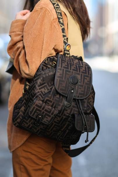 Street style: The Best New Ways To Wear A Backpack. | British Vogue Branded Backpacks, Fendi Backpack, Transitional Fashion, Backpack Outfit, Luxury Backpack, Street Style Bags, Attention Seeking, Fall Trends Outfits, Chanel Backpack