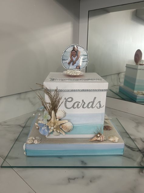 This Beach inspired Gift Card box will be the perfect addition to any wedding,anniversary or beach themed event. It will look absolutely stunning on your gift table. Personalized with Photo box is white but I can do different colors for tulle and ribbon based on preference  Box with base measures: 12Lx9Wx9H Shell measures an additional 3in in height. Elegant Beach Party Decorations, Beachy Wedding Centerpieces, Beach Quinceanera Ideas, Diy Beach Wedding Ideas, Beach Decorating Ideas For Party, Tiffany Blue Beach Wedding, Kourtney Wedding, Beach Themed Wedding Favors, Beach Wedding Reception Decor