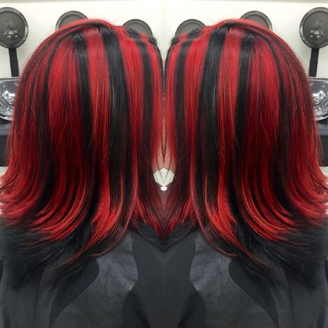 Red and black chunky highlights Bright Red Highlights On Black Hair, Red Skunk Highlights On Dark Hair, Red With Blonde Streak, Split Dye With Chunky Highlights, Black And Red Streaks Hair, Red Black Highlights Hair, Thick Red Highlights On Black Hair, Half Color Half Black Hair, Chucky Hair Color