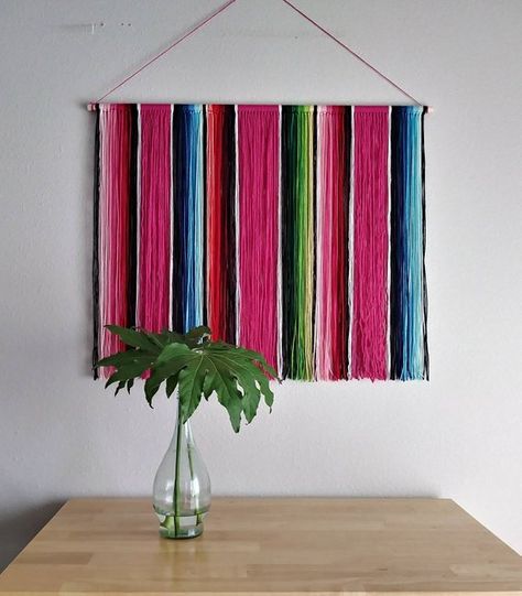 This Mexican Serape Yarn Wall Hanging is inspired by the classic Mexican serape blankets. Styled after the same fun, bright blends of color as in the serape blankets, this beautiful piece of fiber art would look great hung on any wall in your home that needs a bit of that Mexican Style Decor, Pink Bohemian, Serape Blanket, Mexican Serapes, Mexican Home Decor, Yarn Wall, Mexican Home, Yarn Wall Hanging, Southwestern Decorating