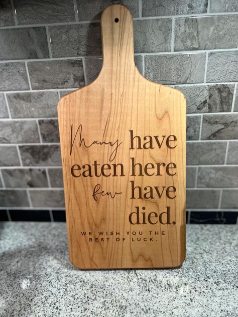 Few Have Died Serving Board | Breadboard | Cheeseboard | Kitchen Decor | Funny Kitchen Decor | Charcuterie Board | Serving Board This listing is for a handmade wooden breadboard with the phrase "Many have eaten here, few have died" engraved on it. This serving board is food safe, and comes with board butter to keep it in tip top shape.  This charcuterie board makes a great gift for someone that is notoriously not an amazing chef or is a fun addition to your own kitchen. These boards are cut by h Laser Charcuterie Board, Laser Engraved Charcuterie Board, Charcuterie Board Engraving Ideas, Lazer Engraver Ideas, Laser Engraving Ideas Projects, Engraver Ideas, Wood Burning Ideas, Cutting Board Crafts, Glowforge Projects