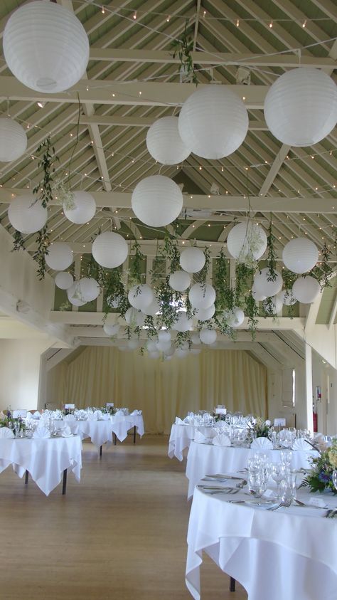 White Paper Lanterns Decor, How To Decorate Ceiling For Wedding, Wedding Paper Lanterns Hanging, Hanging Decor Wedding Ceilings, Lantern Ceiling Wedding, White Lantern Wedding Decor, Wedding Easy Decorations, White Wedding Ceiling Decor, Paper Lantern Wedding Centerpieces