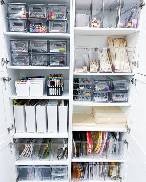 Consider using clear containers or labeled bins to easily identify contents. Storage solution from @tidybyco Gift Organization Storage, Back Office Organization, Art Supplies Storage Shelves, Craft Room Under The Stairs, Clear Storage Ideas, Stationery Cupboard Organisation, Craft Organization Cabinet, Craft Cupboard Storage Ideas, Aesthetic Craft Storage