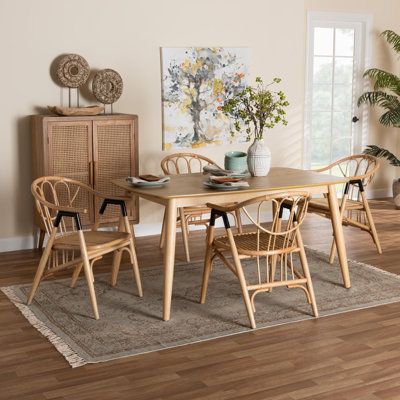 Develop an aura of natural elegance in your space with the boho flair of the dining set. Made in Indonesia, this set includes four chairs and one table. Each chair is handcrafted from natural rattan and is fitted with convenient armrests to encourage casual relaxation. The table of the requires assembly and features a rectangular silhouette with rounded edges to provide ample space for each member of the table. Delivering a refined freshness with eye-catching geometry, the dining set is sure to Wicker Dining Set, 4 Dining Chairs, 5 Piece Dining Set, Extension Table, Baxton Studio, Leather Dining, Modern Bohemian, Dining Room Sets, Natural Brown