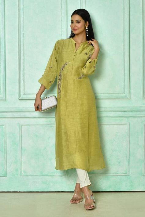 Green long tunic featuring floral motifs embroidery with golden work highlights. Components: 1 Pattern: Hand Embroidered Type Of Work: Floral Pattern Neckline: Stand Collar Sleeve Type: Straight Three Quarter Fabric: Linen Color: Green Other Details:  Attached lining Side slits Approximate product weight (in gms): 700 Note: Pant worn and clutch held by the model is not for sale Occasion: Puja,Work - Aza Fashions Stand Collar Kurti, Stand Collar Kurti Pattern, Hand Embroidered Tunics, Collar Kurti, Tunics Online, Kurti Patterns, Kurta Neck Design, Embroidered Tunic, Long Tunic