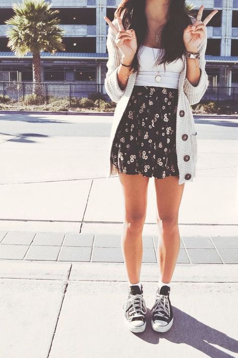 Black skirt, white top, cardigan, and black Converse.