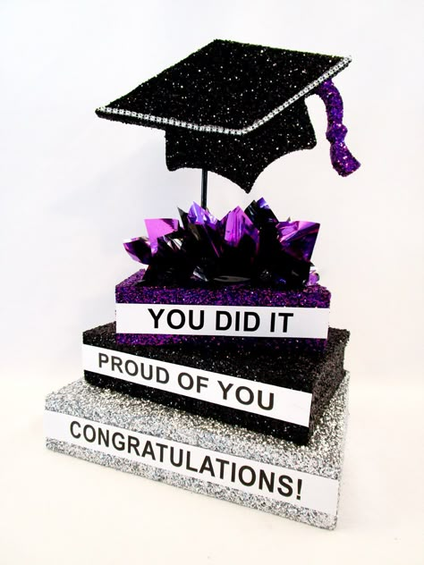 Our custom stack of books with our Styrofoam grad cap cutout makes a simple yet classic graduation table centerpiece. Sample shows the books dark pink and black with metallic tissue puffs, dark pink, black and silver. You can choose other colors, options are listed Changing the colors makes this centerpiece fun and persoanlized to fit your party color theme. Make sure to include the wording you want on the side of each book. Graduation Centerpieces Diy, Graduation Party Table Centerpieces, Teacher Graduation Party, Grad Party Centerpieces, Graduation Party Inspiration, Graduation Table Centerpieces, Kentucky Derby Party Decorations, College Grad Party, Graduation Table