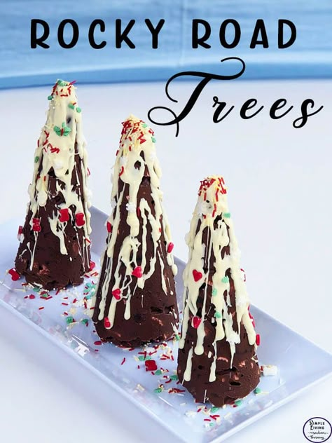 These gorgeous Rocky Road Christmas Trees are a great, edible centrepiece and dessert for your Christmas meal this year. They could also be given as gifts. https://simplelivingcreativelearning.com/rocky-road-christmas-tree/ Rocky Road Christmas Pudding, Edible Centrepiece, Rocky Road Christmas, Christmas Rocky Road, Amazing Christmas Desserts, Christmas Afternoon Tea, Xmas Cakes, Rocky Road Recipe, Christmas Tree Food