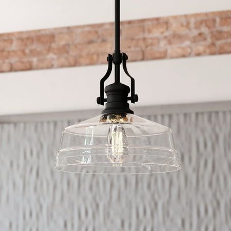 The Beloit pendant adds a welcoming and inviting feel to your kitchen or living spaces. Soft curving lines finished in matte black paired with a large clear seeded glass shade create a look that accents the most comfortable spaces. Combine that with a vintage Edison style filament bulb to complete the look. Bring a level of sophistication to your trendy farmhouse or urban style with this pendant. Size: 12-in. W x 17-in. H x 12-in. D. Over Sink Lighting Kitchen Pendants, Light Over Sink, Kitchen Island Hanging Lights, Lights Over Kitchen Island, Trendy Farmhouse, Modern Farmhouse Lighting, Sink Lights, Farmhouse Kitchen Lighting, Black Farmhouse