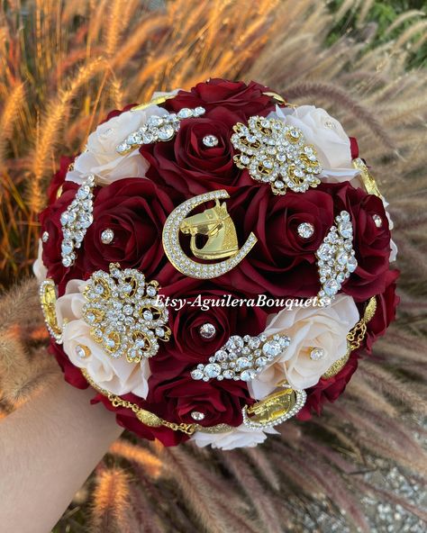 A beautiful charro themed bouquet for your special occasion. This bouquet is handmade to order with red silk roses, gorgeous sparkling gold brooches and rhinestones. We can do it in different colors. Please select the color of your choice. Please message me if you would like silver brooches instead.  *This bouquet is 10 inches in diameter* Please contact me with any questions! :) Charro Style Quinceanera Decor, Charro Quince Crown, Red And Gold Ramo, Red Quinceanera Ramo, Red And White Charro Quinceanera Decorations, Red And White Quinceanera Cake, Red And Gold Quince Dress Charro, Red Charro Quinceanera Decorations, Rodeo Quinceañera