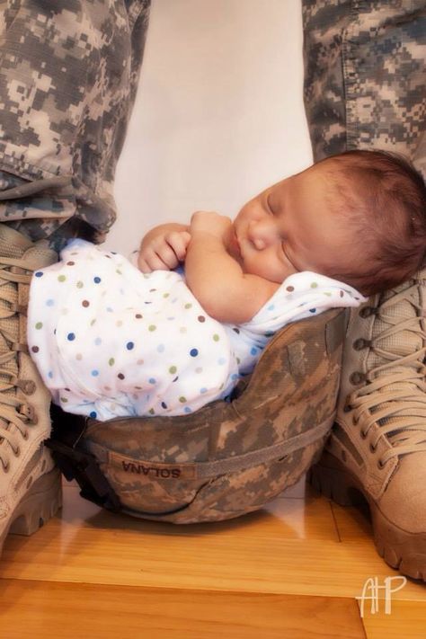 Army baby. Photo shoot. Dad's military helmet. Son, handsome