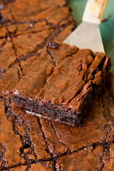 My Sheet Pan Brownies have the best shiny crackly tops we all know and love, and a rich, chewy, and fudgy brownie beneath. The crumb is dense and moist and has the perfect indulgent chocolate flavor. It's a melt in your mouth kind of brownie and almost impossible to resist reaching for just one more! These brownies are perfect for a crowd, really convenient to make, and easy to transport! Brownies never fail to bring joy and if you ask me, the answer is always brownies...err, sheet pan ... Brownie Recipes For A Crowd, One Pan Brownies, Sheet Brownies Easy, Easy Transportable Desserts, Brownies For A Crowd Sheet Cakes, Sheet Pan Brownies For A Crowd, Sheet Pan Deserts, Best Chewy Brownie Recipe, Brownies Sheet Pan