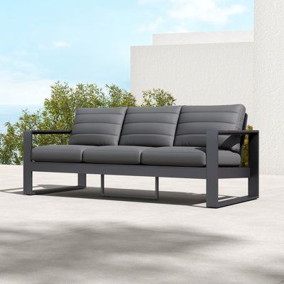 This modern sofa is crafted from durable aluminum and features plush cushions for ultimate comfort. The clean lines and minimalist design will complement any contemporary patio or deck. Whether you're hosting a party or simply relaxing with family and friends, this sofa is sure to become your new favourite spot to gather. | Latitude Run® Quanetta 78" Wide Outdoor Patio Sofa w/ Cushions Black 33.0 x 78.4 x 33.4 in, Plastic | C110805281 | Wayfair Canada Garden Steel Furniture, Gray Patio Furniture, Outdoor Patio Sofa, Steel Sofa, Sofa With Cushions, Metal Outdoor Furniture, Metal Sofa, Contemporary Patio, Restaurant Seating