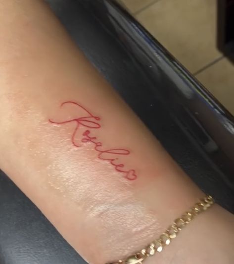 Red Ink Tattoos Wrist, Name Tattoos Red Ink, Cute Name Tattoos For Women, Red Name Tattoo, Red Script Tattoo, Last Name Tattoo For Women, Small Red Tattoo, Cute Name Tattoos, Small Name Tattoos