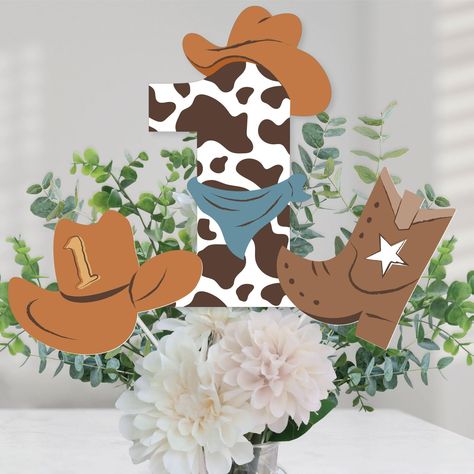 PRICES MAY VARY. My First Rodeo Table Toppers Includes 15 centerpiece cut-outs in 3 different shapes, 15 sticks, and stickers for easy assembly, and are a great addition to any Western 1st Birthday Party. Party Must-Have: The Western centerpiece cut-out SIZE 5 “1” Shapes - 6.75 inches wide x 10.75 inches tall, 5 Cowboy Boot Shapes – 5 inches wide x 6 inches tall, and 5 Cowboy Hat Shapes - 7 inches wide x 5 inches tall. Easy Table Decor: The Western party table decorations can be used as centerpi My First Rodeo Birthday Boy Decorations, My First Rodeo Party, Cowboy 1st Birthday Party, Cowboy Centerpieces, Cowboy First Birthday, Western Table, Rodeo Birthday Parties, Wild West Party, Rodeo Party