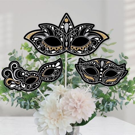 Masquerade Centerpiece Sticks INCLUDES 15 Carnival Mask table toppers in three different shapes, 15 sticks, and stickers for easy assembly. Masquerade Night party table decorations are perfect for any Carnival Mask Party. Masquerade Party Centerpiece Sticks SIZE 5 - Mask Shape 1 Table Toppers (10.75" wide x 5.5" tall), 5 - Mask Shape 2 Table Toppers (7.75" wide x 4.5" tall), and 5 - Mask Shape 3 Table Toppers (6.75" wide x 3.5" tall). The unique design and variety of pieces makes this table deco Masquerade Party Decorations Theme, Masquerade Party Centerpieces, Masquerade Party Themes, Masquerade Centerpieces, Masquerade Decorations, Elegant Table Decorations, Prom Gold, Masquerade Party Decorations, Masquerade Ball Party