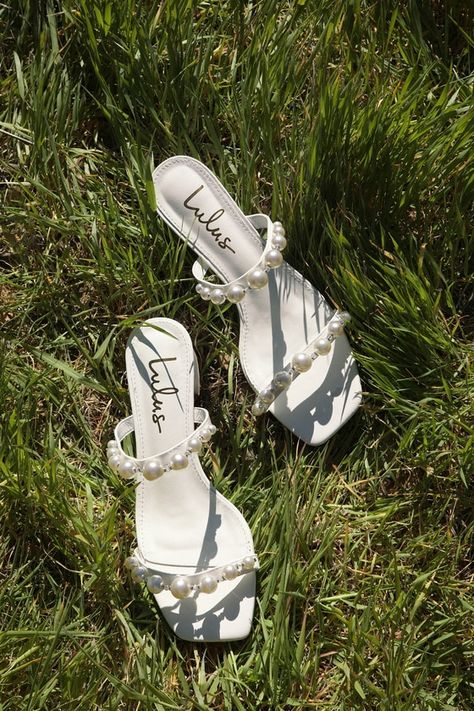 All the odds are in your favor thanks to the sweet charm the Lulus Damii White Pearl Sandals are serving! Smooth faux leather shapes these eye-catching sandals that have a square toe bed and a slide-on silhouette. The slender toe strap and vamp strap are adorned with faux pearls (in varying sizes) and clear beads throughout. Chic low block heel completes the trendy look! 1. 5" wrapped block heel. Cushioned insole. Rubber sole has nonskid markings. MAN MADE MATERIALS. Imported. Lulus | Damii Whit Short Pearl Heels, White Heels With Pearls, Pearl Heels, Wedding Shoes Sandals, Homecoming Shoes, White Sandal, Pearl Shoes, Chic Dress Classy, Pearl Sandals