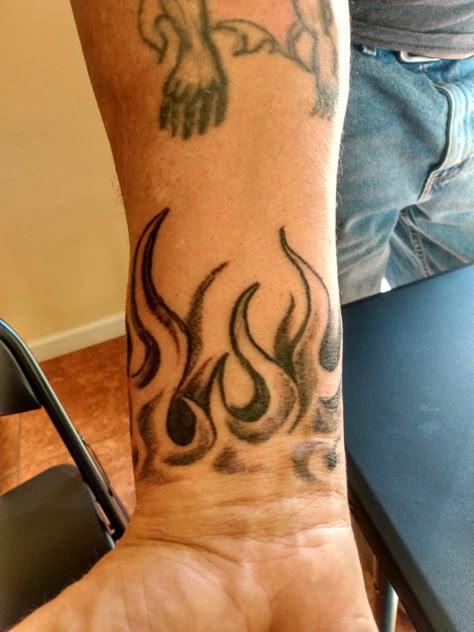 Fire Wrist Tattoos Men, Wrist Filler Tattoo Men, Flames Drawing Tattoo, Red Ink Neck Tattoo Men, Neck Flame Tattoo, Fire Wrist Tattoo, Easy Forearm Tattoos, Flame Wrist Tattoo, Fire Hand Tattoo