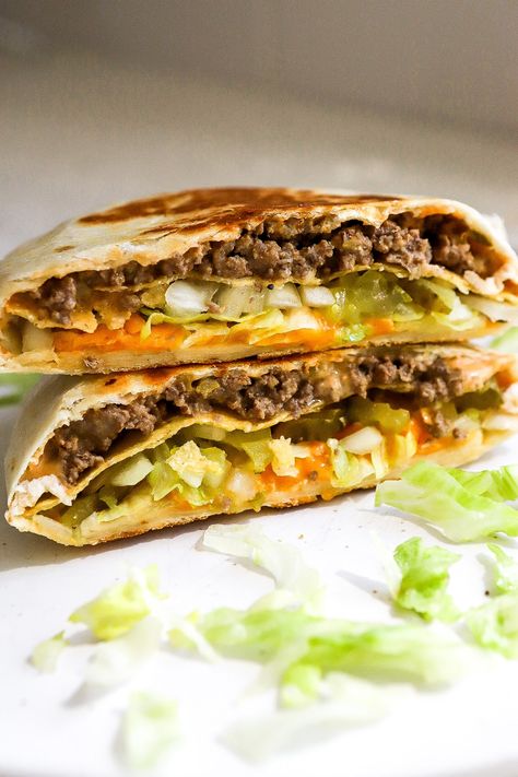 Side view of Big Mac Crunchwrap on white plate with fresh lettuce, pickles and white onions. Big Mac Crunchwrap, Big Mac Crunch Wrap Recipe, Big Mac Crunch Wrap, Crunch Wrap Recipe, Perfect Bar Recipe, Breakfast Crunchwrap, Crunchwrap Recipe, Homemade Big Mac Sauce, Mac Sauce Recipe