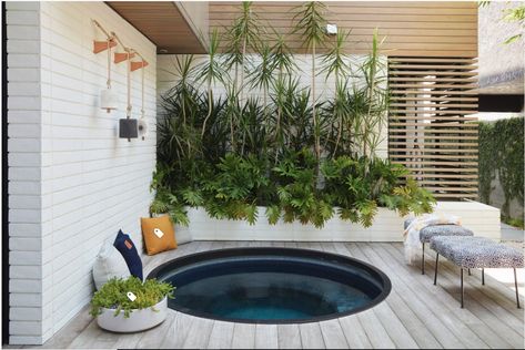 A sunken spa nestles into the corner of the courtyard, with a metal ring encircling it and concealing the cut ends of the ipe deck. The design team suggested a round tub early on in the project, both to contrast the rest of the courtyard’s mostly square design and to suggest the feeling of a Japanese soaking tub.   Glass mosaic tiles cover the spa, creating a dark and subtle space. “[It adds a] quietness and mystique,” Jones says. “It’s not bright and blue.” Spa On Deck, Sunken Hot Tub, Contemporary Deck, Rustic Pergola, Japanese Soaking Tubs, Hot Tub Deck, Hot Tub Backyard, Hot Tub Garden, Wooden Deck