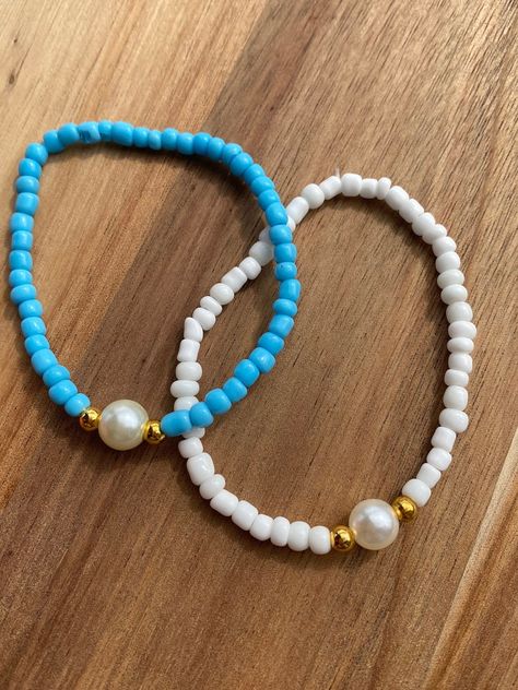 Comes in blue or white please message once you order with the color you want  Clay bead bracelet Approximately 6.5 inches long  Elastic band.  My shop has other designs as well!! Please visit my Instagram  emr_smileybeads Please message me if you have any questions or need a bigger quantity!  thank you for supporting my small business! Brad Bracket Ideas, Micro Bead Bracelet, Small Beaded Bracelets Ideas, Clay Bead Bracelet Aesthetic, Small Beads Bracelets Ideas Aesthetic, Cute Bead Bracelet Ideas Aesthetic, Bracelet Ideas For Small Business, Clay Bead Bracelet Ideas With Pearls, Sea Bead Bracelets Ideas